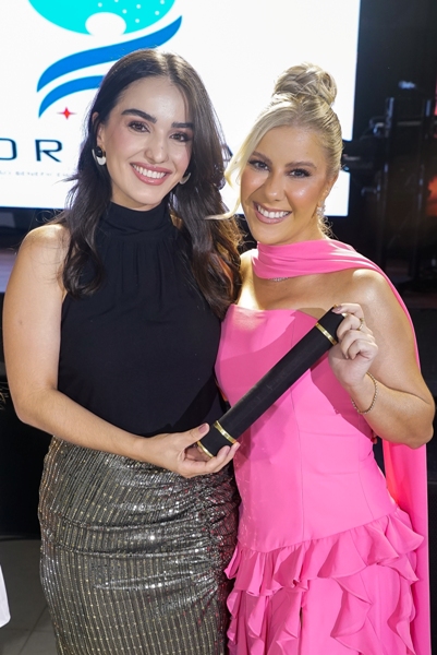 A Dra. Maria Luíza entrega para a formanda 